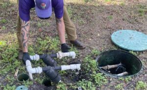 A man doing emergency maintenance on a septic system.