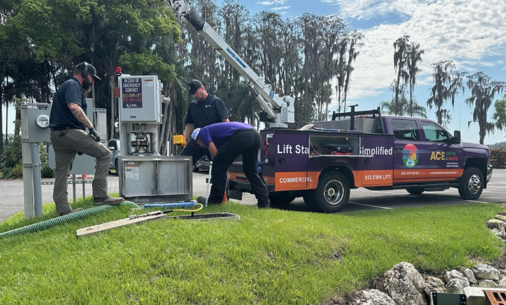 Septic service technicians in Lecanto, FL diagnosing issues before repairing a lift station.