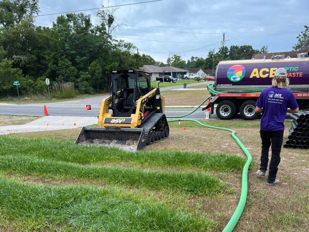 A digger clearing the surface of a lift station septic system in Lakeland, FL