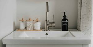 A bathroom sink with a drain pipe connected to a septic system.