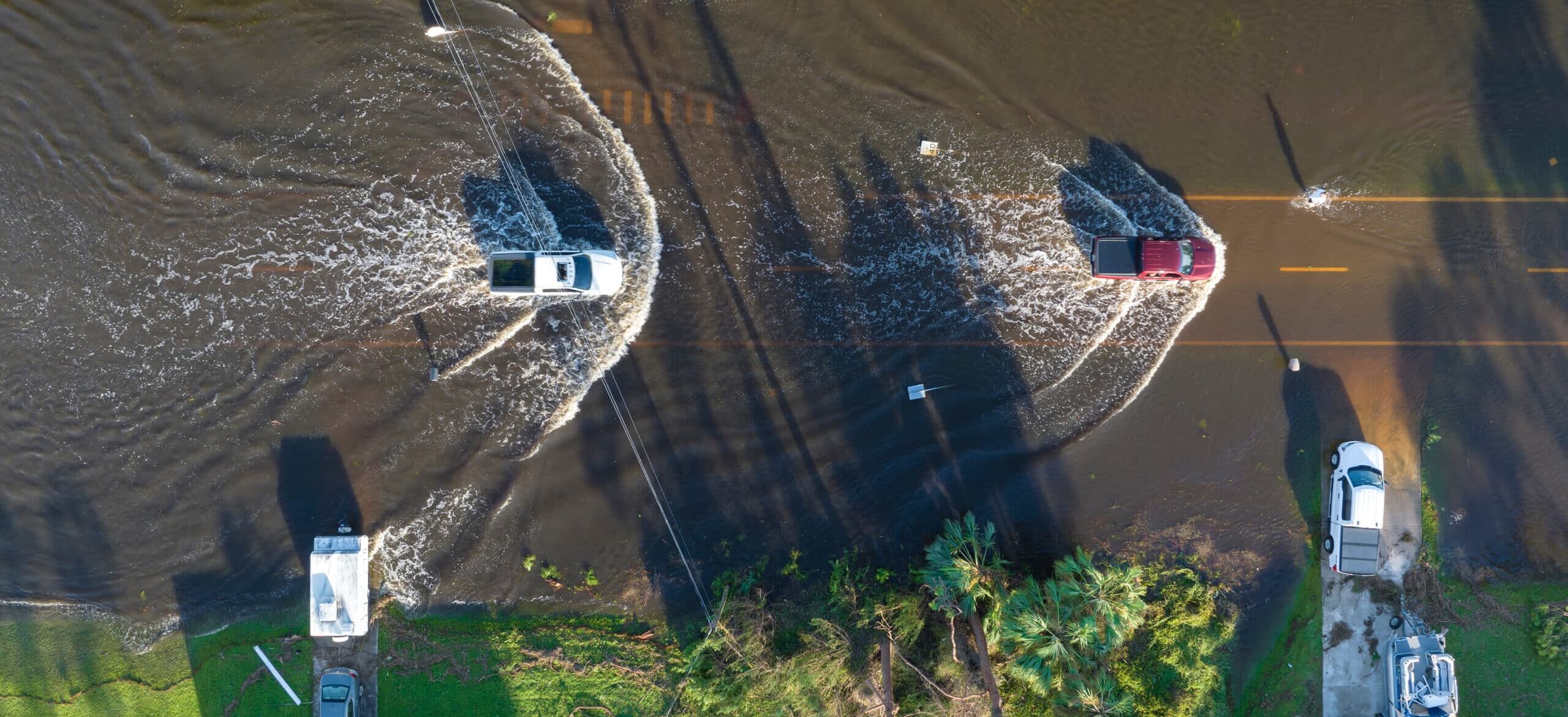 Cars driving on a flooded road in Tampa Bay, Florida.