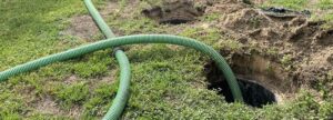 An underground septic tank with a hose pumping out septic waste.